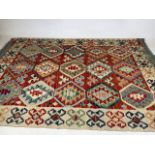 A hand knotted wool Chobi Kilim rug.W:125cm x H:179cm