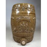 A ceramic wine barrel decorated with grape leaves a coat of arms and statue lions. Stamped Powell