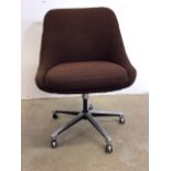 A mid century swivel office char on castors with brown upholstery. W:55cm x D:57cm x H:83cm