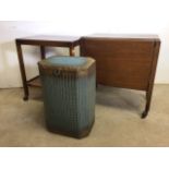 Lloyd loom lusty laundry basket also with two mid century tea trolleys one with folding drop flap