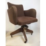 A Hillcrest mid century swivel office chair with Hillcrest label to metal base on oak stand with