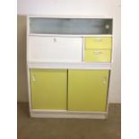 A Mid century 1950s kitchen cupboard with sliding glazed doors to top drop down larder and two