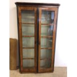 A Victorian satin wood veneered glazed cupboard with four pine shelves. W:108cm x D:28cm x 189cm
