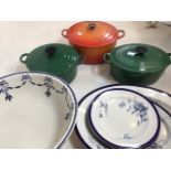 Le Creuset casserole dishes orange and green, Worcester blue and white plates also with a blue and