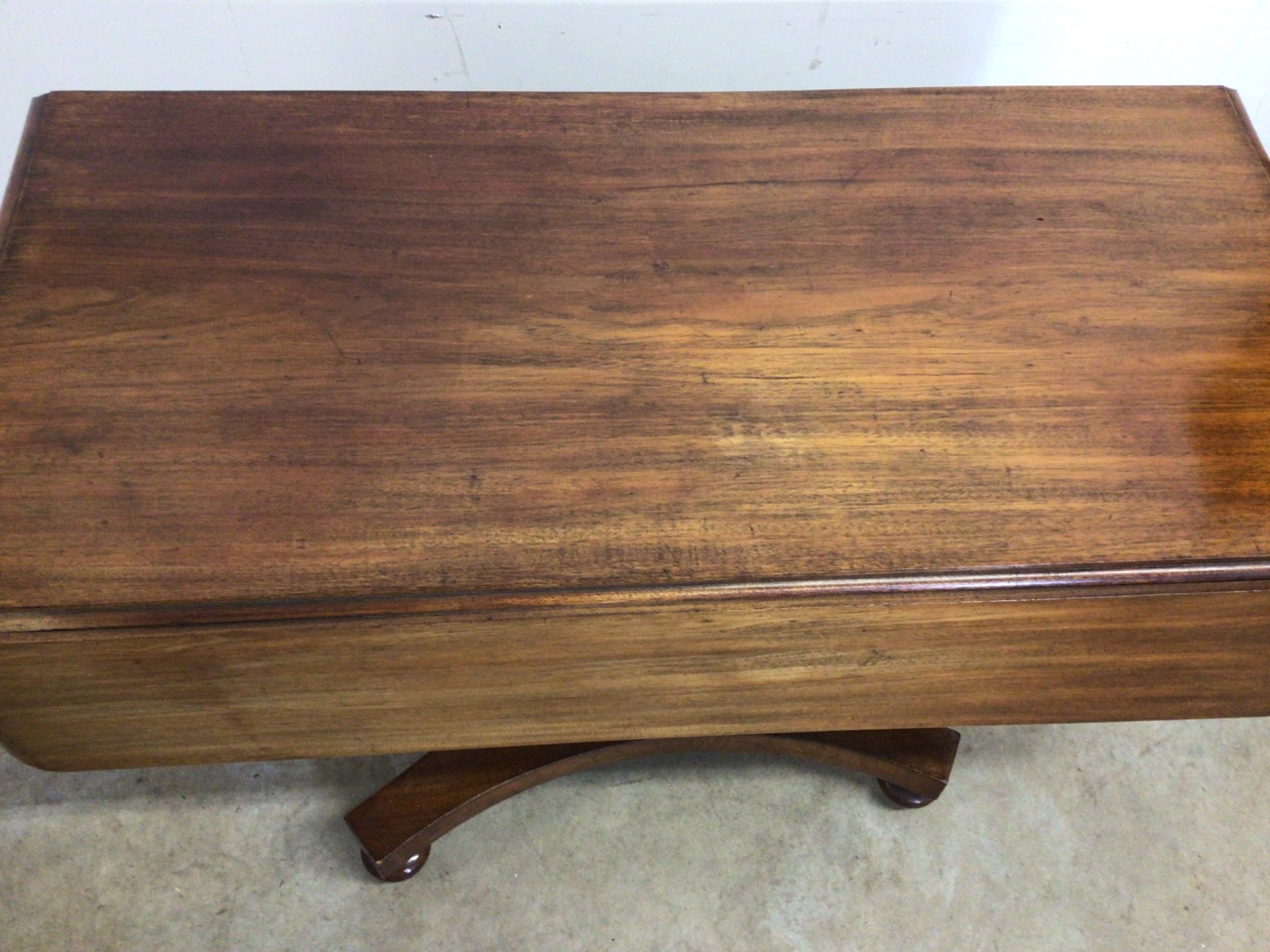 A Victorian Pembroke table with drop leaf sides, pedestal base with turned feet on metal castors. - Image 5 of 6