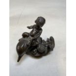 A bronze effect model of a small boy riding a dolphin in manner of Giovanni Schoeman W:14cm x H: