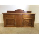 A blond wood sideboard, brass handles with two cupboard and two drawers. W:134cm x D:90cm x H:75cm