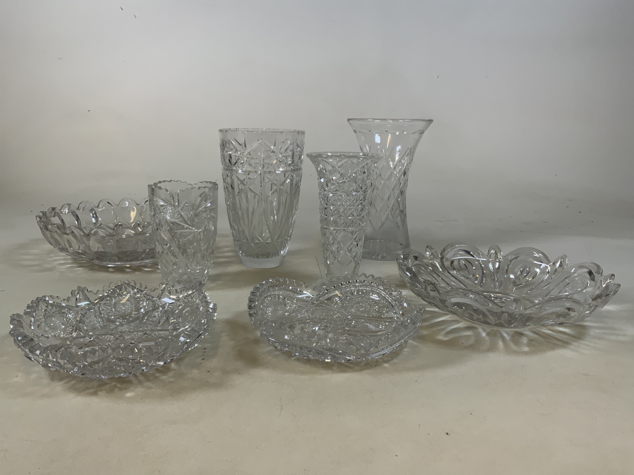 A collection of cut and moulded glass including two strawberry bowls, vases and large bowls