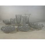 A collection of cut and moulded glass including two strawberry bowls, vases and large bowls