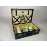 An early Brexton picnic hamper with four place settings in wooden box with yellow interior. Original