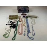 A box of costume jewellery and other items including glass beads, mother of pearl buckles