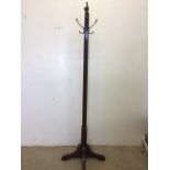 An early 20th century mahogany coat stand with chamfered finish and four brass hooks. H:173cm
