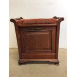 A mahogany piano stool with pull down sheet music storage compartment. W:54cm x D:37cm x H:56cm