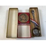 A solid silver christening spoon also with a bronze commemorative medal for George W. Giles OBE