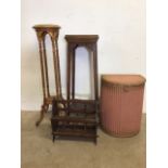 Two plant stands also with a Lloyd loom lusty laundry basket and a magazine rack. Round torchaire