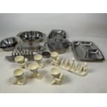 A collection of Lurpak ceramics including a toast rack and six egg cups together with stainless