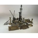 A large quantity of brass and copper items including taps, door knockers, lamps and candle sticks