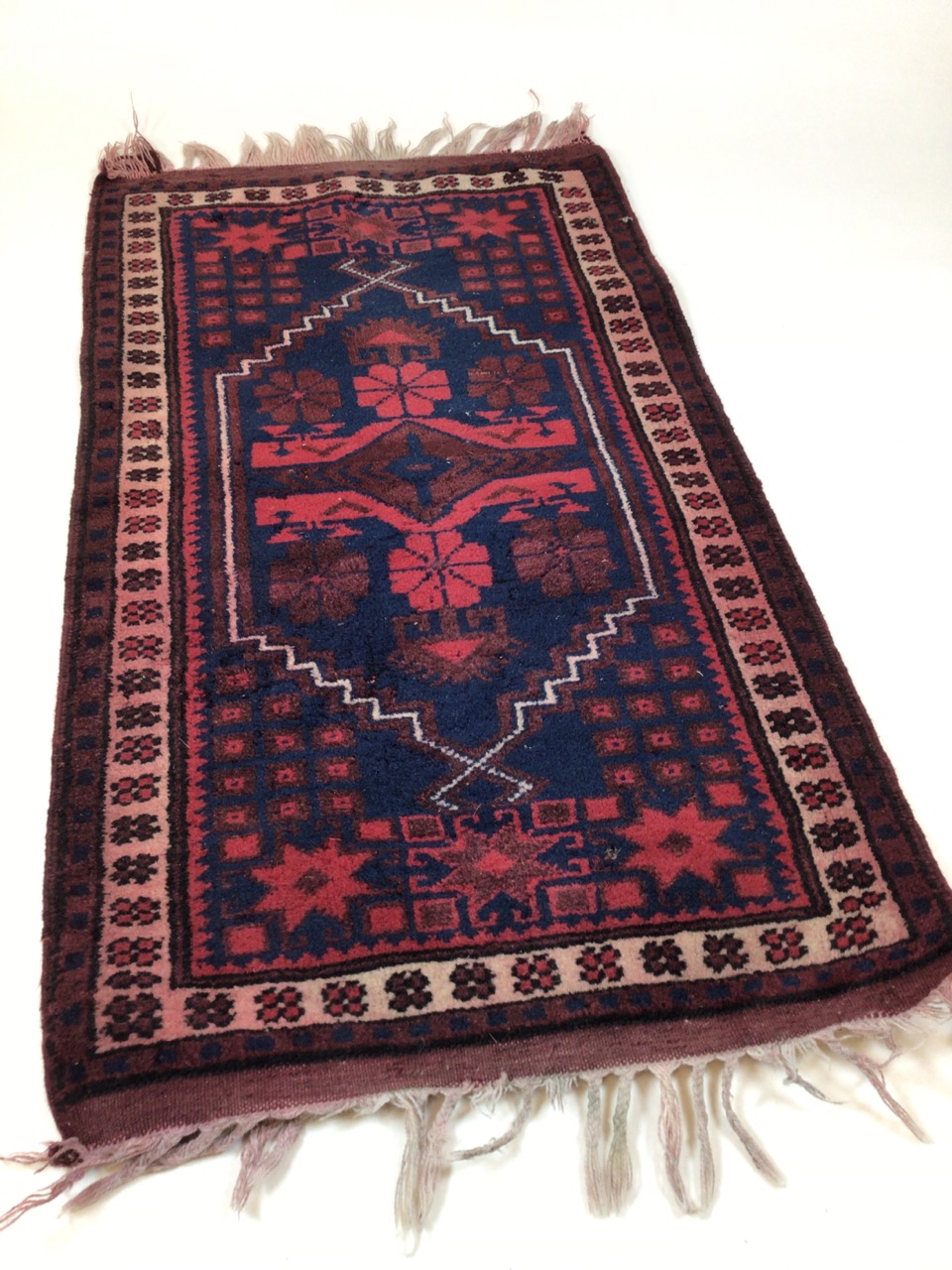 A Turkish prayer rug, maroon and navy. W:103cm x D:57cm x - Image 2 of 4