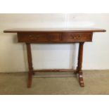 A 20th century French Cherry wood hall table with two drawers with brass handles, stretcher bar to