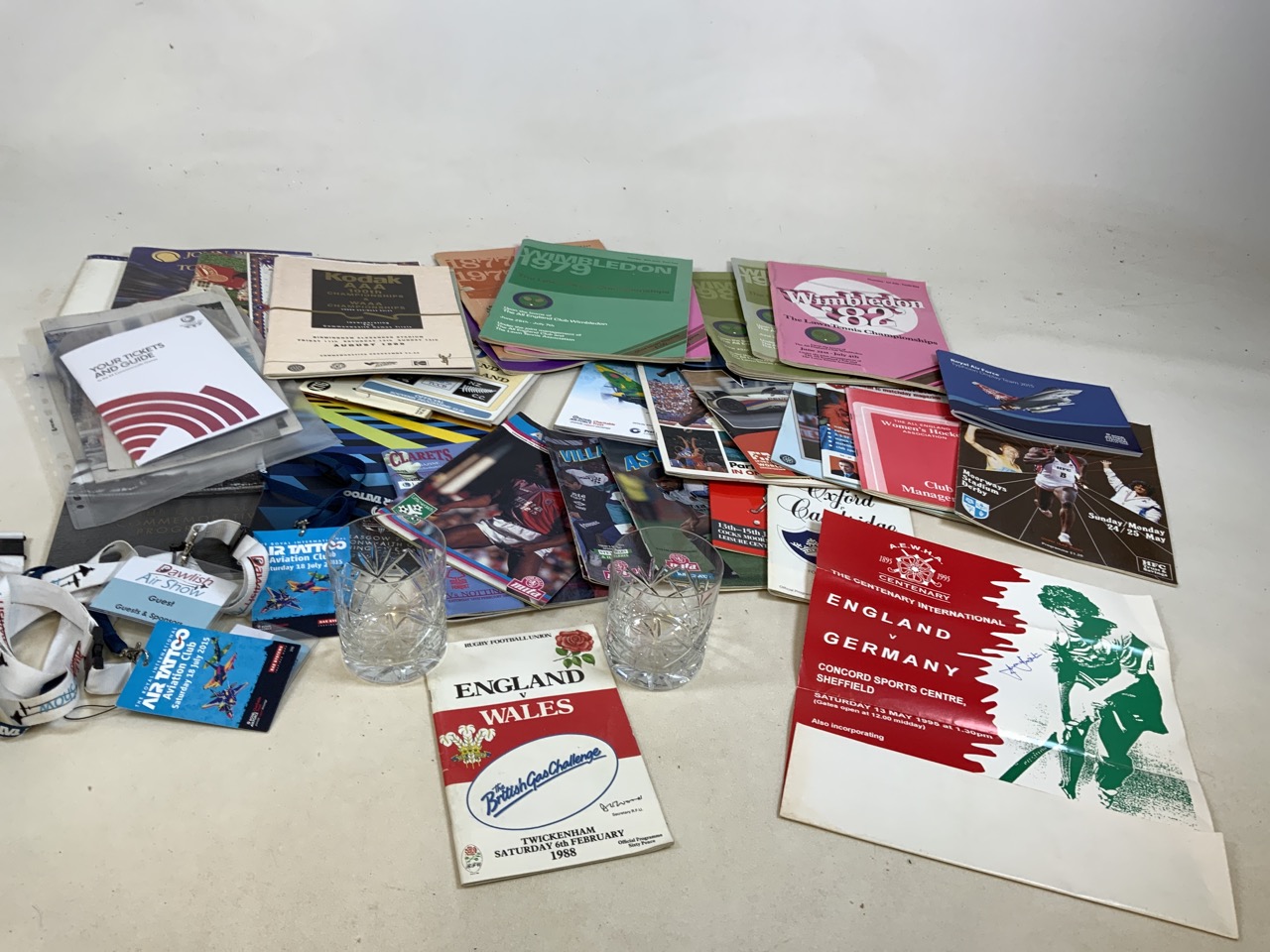 A collection of sporting programmes including Wimbledon, womenâ€™s hockey, Glasgow Commonwealth