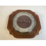 A wooden wall barometer with presentation plaque on reverse dated 1933 W:30cm x D:4.5cm x H:30cm