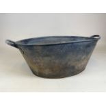 A tin bath with drainage holes in the bottom. W:49cm x D:79cm x H:27cm