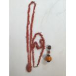 Two coral necklaces also with large amber beads.