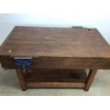 An antique Hardwood workbench with two vices and a lower shelf. W:140cm x D:85cm x H:78cm