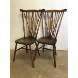 A pair of Ercol style stick back chairs. W:36cm x D:44cm x H:101cm