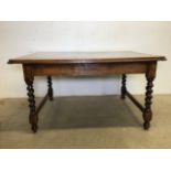 An early 20th century oak dining table with barley twist legs and side stretcher bars. W:138cm x D: