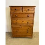 A modern solid pine chest of drawers with large deep drawer to base beneath two long and two short