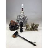 A 20th century pottery lamp together soapstone and wooden collectibles including lion book ends (