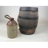 An old coopered barrel together with a cider flagon with metal handle from Cheddar Barrel W:34cm x
