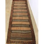 An antique eastern runner with Aztec influence. W:290cm x H:105cm