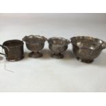 Two Indian silver salts also with a white metal glass holder and a white metal bowl. H:7cm