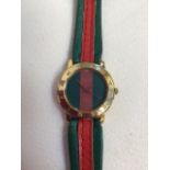 A ladies watch stamped Gucci.