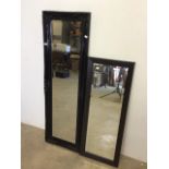 A modern black decorative baroque style mirror with bevelled edge also with another modern mirror.