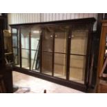 A large 12â€™ shop cabinet with six glazed doors with brass handles. Separate cornice and base. W: