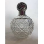 A silver topped scent bottle cobbled glass. Birmingham 1912. H:13cm