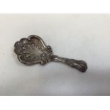 A Victorian sterling silver caddy spoon with repousse acanthus leaf decoration. Birmingham by