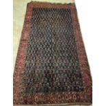 A vintage Persian Bihar rug with navy blue ground and terracotta borders. W:310cm x H:170cm