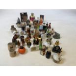 A large collection of miniatures including whisky, brandy, and ceramic miniatures. A few empties for