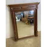 A oak framed pier mirror with carved details and turned columns. W:87cm x H:108cm