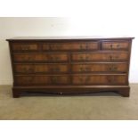 A large sideboard with nine drawers with brass handles. W:154cm x D:48cm x H:76cm