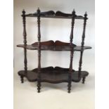 A 19th century mahogany three tier whatnot with shaped shelves, turned supports and legs. W:107cm