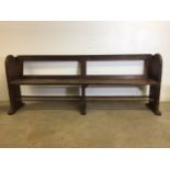 A pitch pine pew with reversable back rest and double footrests. W:215cm x D:50cm x H:82cm