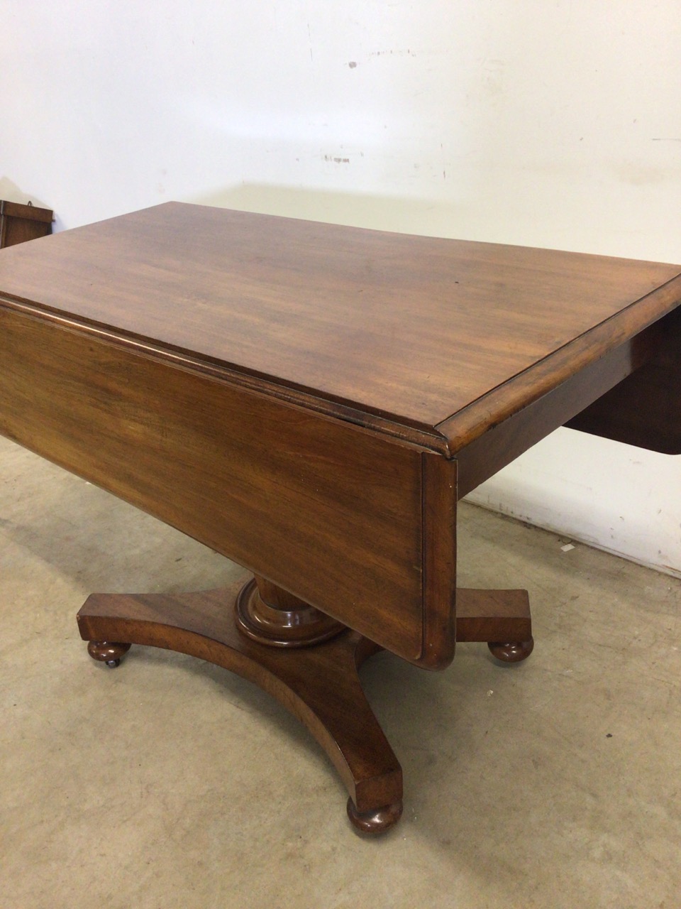 A Victorian Pembroke table with drop leaf sides, pedestal base with turned feet on metal castors. - Image 3 of 6