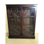 A small mahogany glazed bookcase with interior shelves. W:83cm x D:27cm x H:102cm