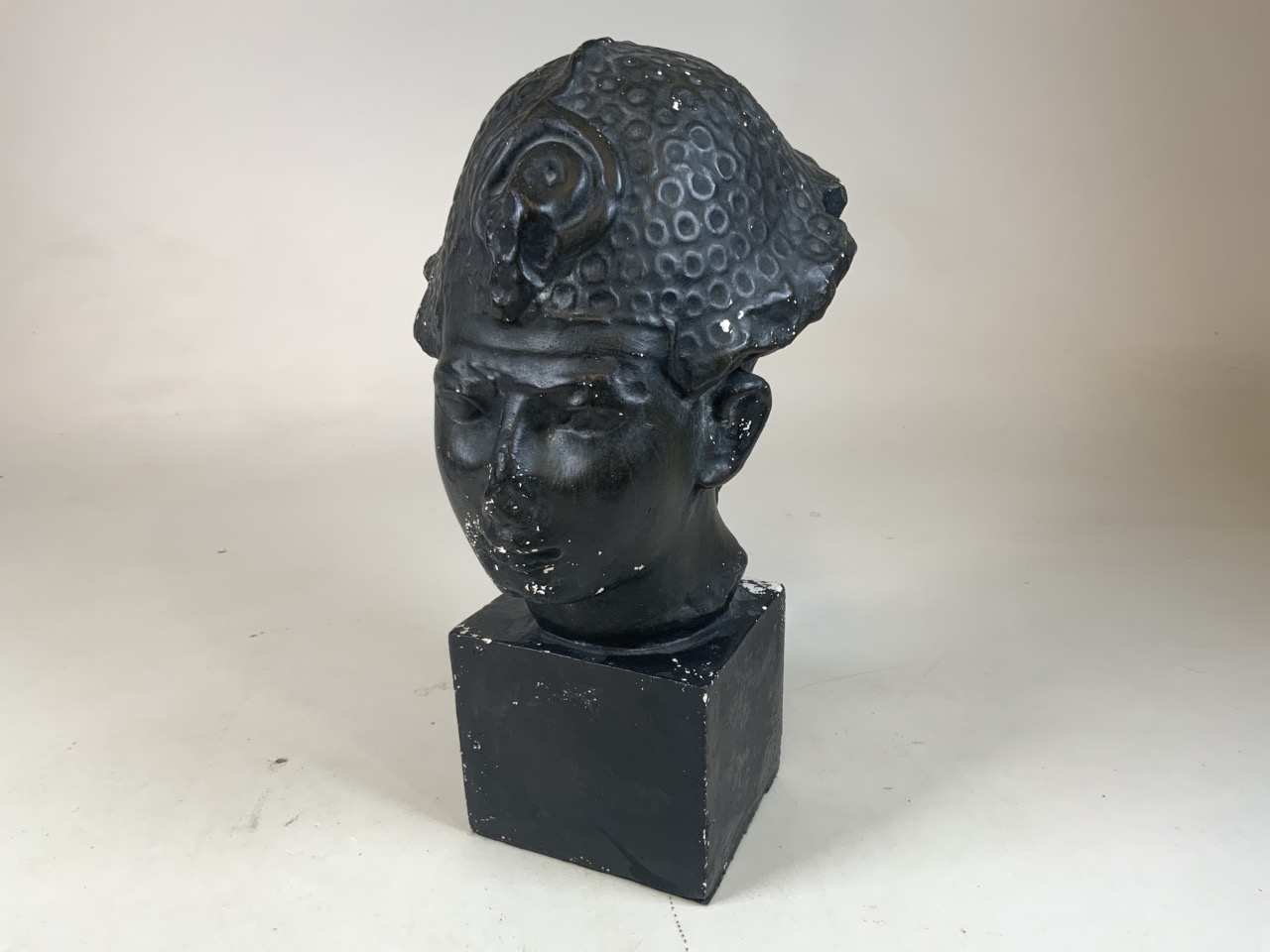 A painted plaster oriental style bust on square plinth W:22cm x H:43cm