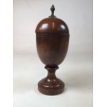 A large mahogany urn with acorn finial to lid. H:36cm